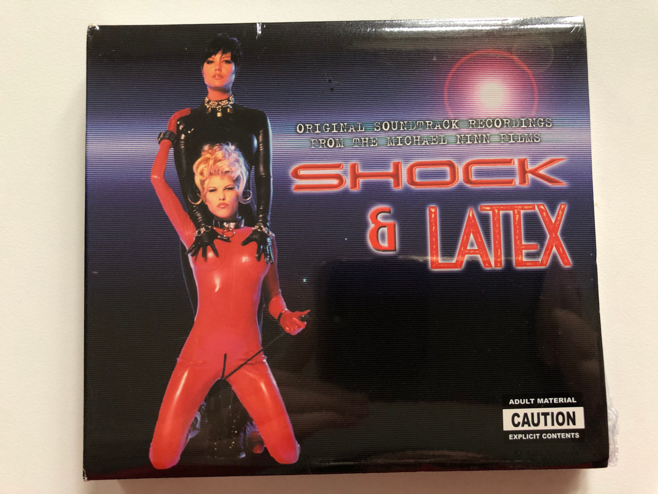 https://cdn10.bigcommerce.com/s-62bdpkt7pb/products/0/images/221089/Shock_Latex_Original_Soundtracks_Recordings_From_The_Michael_Ninn_Films_Popshot_2x_Audio_CD_SHOT001_1__74600.1649349958.1280.1280.JPG?c=2&_gl=1*1thk9iu*_ga*MjA2NTIxMjE2MC4xNTkwNTEyNTMy*_ga_WS2VZYPC6G*MTY0OTM0OTYyMy4zNDguMC4xNjQ5MzQ5NjIzLjYw