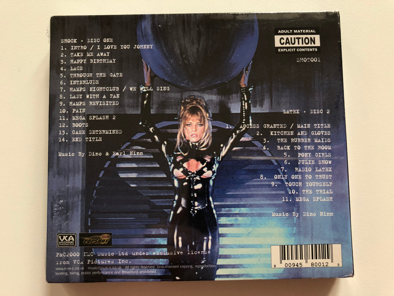 https://cdn10.bigcommerce.com/s-62bdpkt7pb/products/0/images/221090/Shock_Latex_Original_Soundtracks_Recordings_From_The_Michael_Ninn_Films_Popshot_2x_Audio_CD_SHOT001_2__91324.1649349959.1280.1280.JPG?c=2&_gl=1*1thk9iu*_ga*MjA2NTIxMjE2MC4xNTkwNTEyNTMy*_ga_WS2VZYPC6G*MTY0OTM0OTYyMy4zNDguMC4xNjQ5MzQ5NjIzLjYw