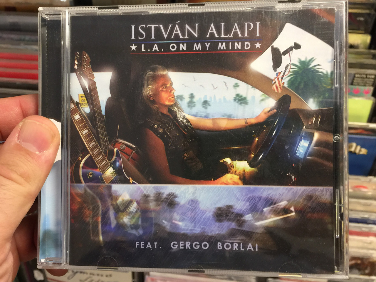 https://cdn10.bigcommerce.com/s-62bdpkt7pb/products/0/images/221335/Istvn_Alapi_Feat._Gergo_Borlai_L._A._On_My_Mind_Audio_CD_5998176180006_1__95208.1649669118.1280.1280.JPG?c=2&_gl=1*1bgmcea*_ga*MjA2NTIxMjE2MC4xNTkwNTEyNTMy*_ga_WS2VZYPC6G*MTY0OTY1NzEzNy4zNTMuMS4xNjQ5NjY4OTg5LjE0