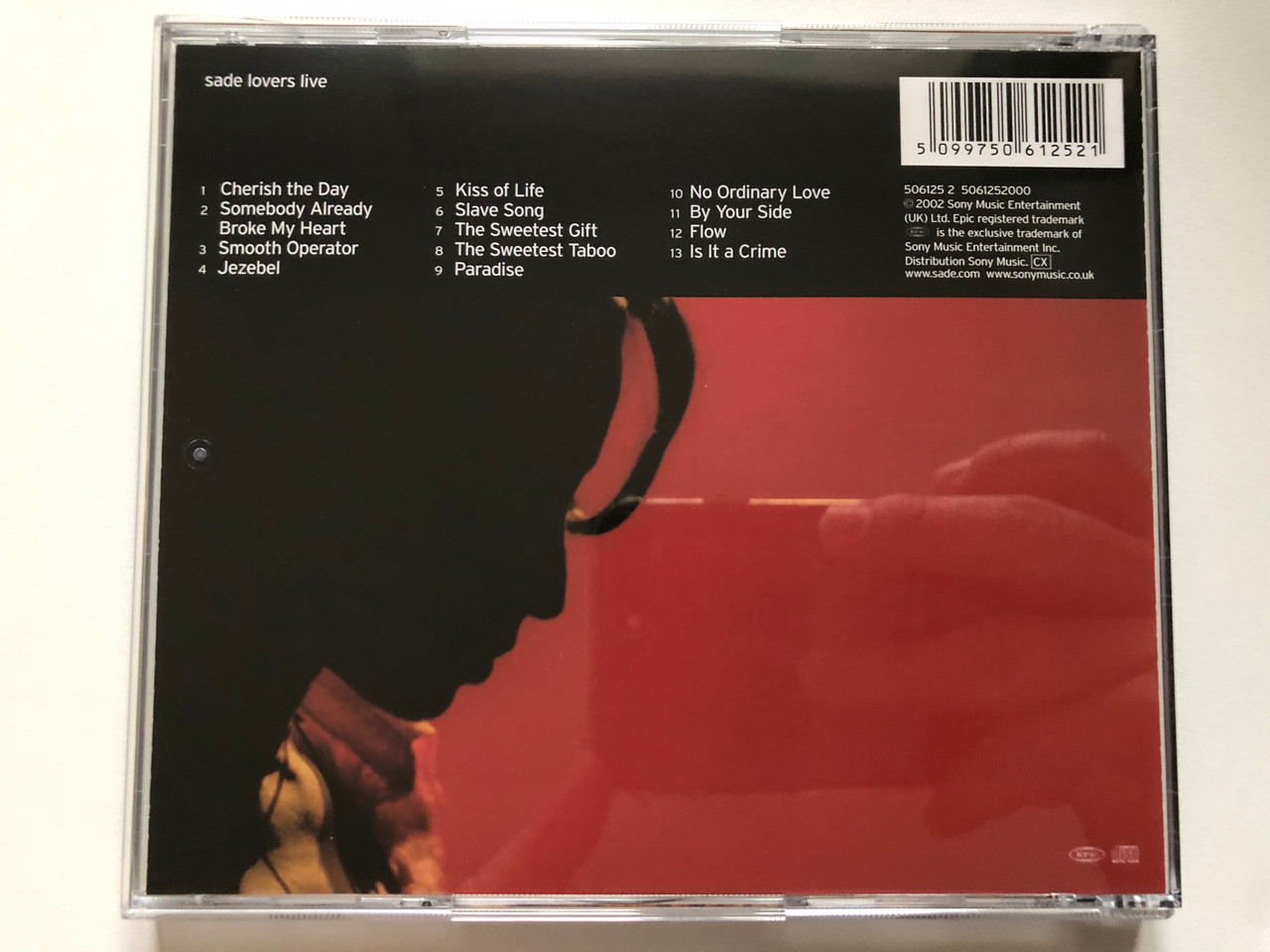 https://cdn10.bigcommerce.com/s-62bdpkt7pb/products/0/images/221996/Sade_Lovers_Live_Epic_Audio_CD_2002_506125_2_2__59754.1649938747.1280.1280.JPG?c=2&_gl=1*1og8r9*_ga*MjA2NTIxMjE2MC4xNTkwNTEyNTMy*_ga_WS2VZYPC6G*MTY0OTkzODE4Mi4zNTYuMS4xNjQ5OTM4NTAwLjU4