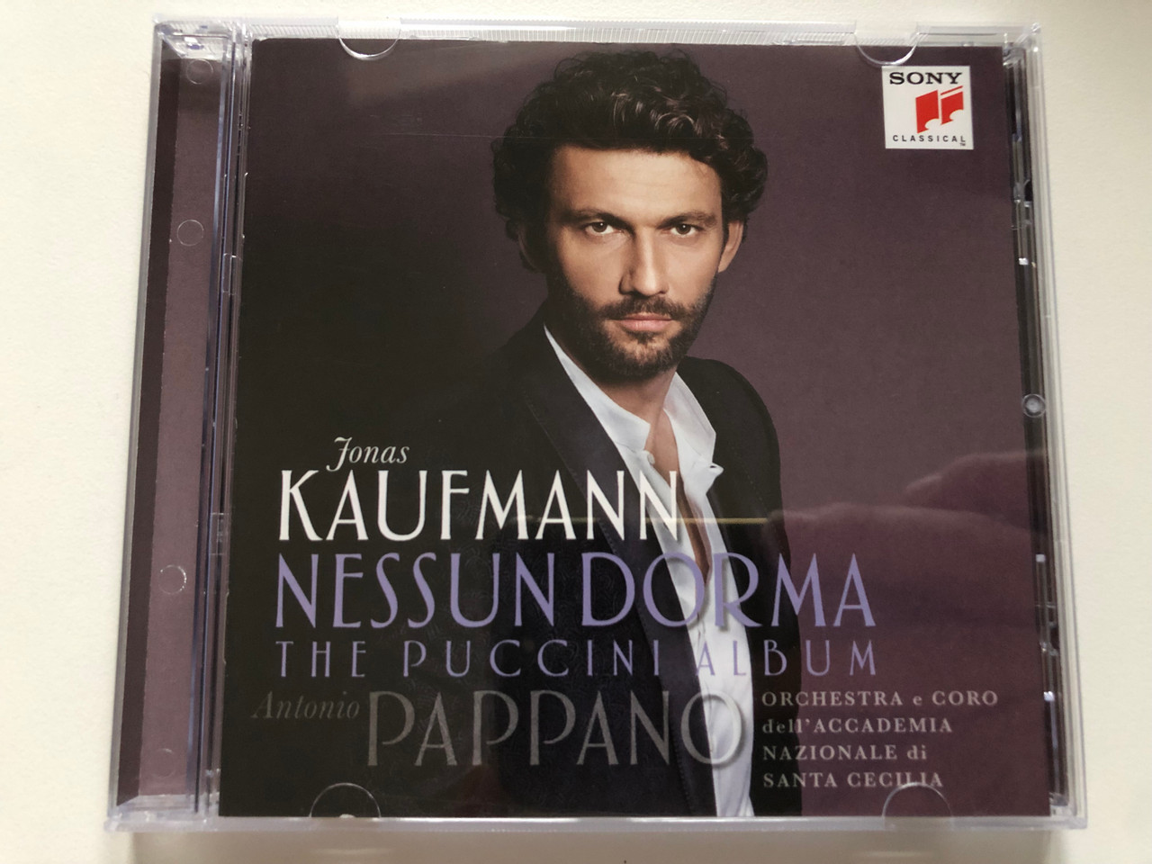 https://cdn10.bigcommerce.com/s-62bdpkt7pb/products/0/images/222119/Jonas_Kaufmann_-_Nessun_Dorma_-_The_Puccini_Album_-_Antonio_Pappano_Orchestra_e_Coro_dell_Accademia_Nazionale_di_Santa_Cecilia_Sony_Classical_Audio_CD_2015_88875092492_1__36887.1650031783.1280.1280.JPG?c=2&_gl=1*a3y57y*_ga*MjA2NTIxMjE2MC4xNTkwNTEyNTMy*_ga_WS2VZYPC6G*MTY1MDAyNzY2OS4zNTguMS4xNjUwMDMxNjIxLjU1