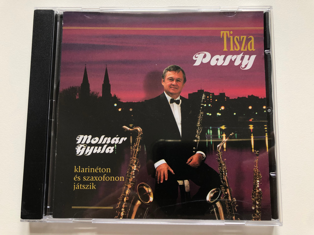 https://cdn10.bigcommerce.com/s-62bdpkt7pb/products/0/images/223554/Tisza_Party_-_Molnar_Gyula_-_klarineton_es_szaxofonon_jatszik_Audio_CD_MGY111_1__22753.1650552057.1280.1280.JPG?c=2&_gl=1*13cjy38*_ga*MjA2NTIxMjE2MC4xNTkwNTEyNTMy*_ga_WS2VZYPC6G*MTY1MDU0ODUxNi4zNjQuMS4xNjUwNTUxNzAyLjEz