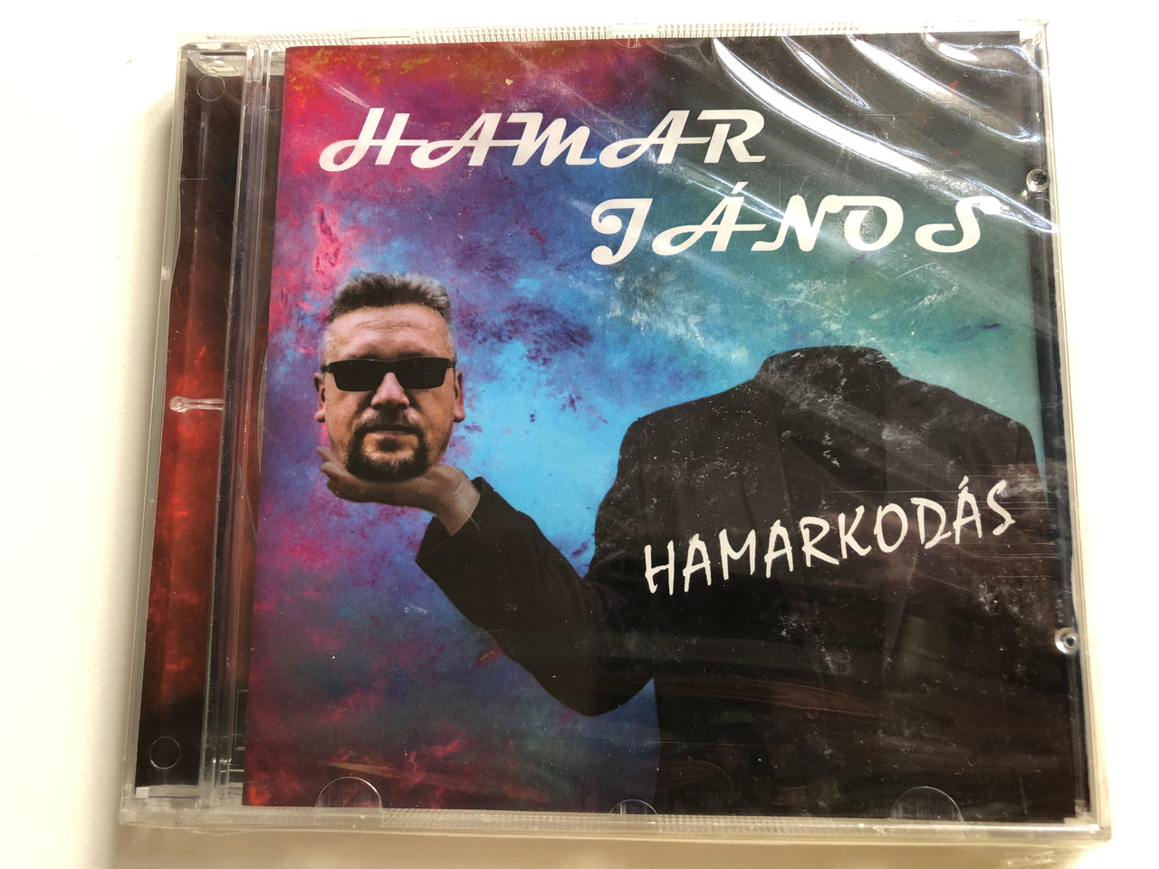 https://cdn10.bigcommerce.com/s-62bdpkt7pb/products/0/images/226681/Hamar_Janos_-_Hamarkodas_Hamer_Music_Audio_CD_FL050_1__50573.1651818683.1280.1280.JPG?c=2&_gl=1*14g31kc*_ga*MjA2NTIxMjE2MC4xNTkwNTEyNTMy*_ga_WS2VZYPC6G*MTY1MTgxNjI5NC4zODUuMS4xNjUxODE4NTE5LjMw