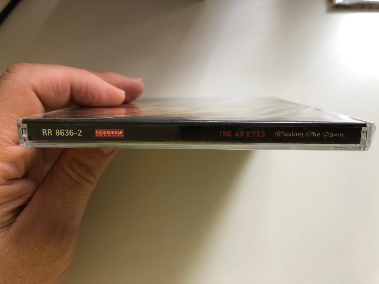 https://cdn10.bigcommerce.com/s-62bdpkt7pb/products/0/images/227218/The_69_Eyes_Wasting_The_Dawn_Roadrunner_Records_Audio_CD_1999_RR_8636-2_3__66576.1652247448.1280.1280.JPG?c=2&_gl=1*16wjgfh*_ga*MjA2NTIxMjE2MC4xNTkwNTEyNTMy*_ga_WS2VZYPC6G*MTY1MjI0NzQ2MS4zOTEuMC4xNjUyMjQ3NDYxLjYw