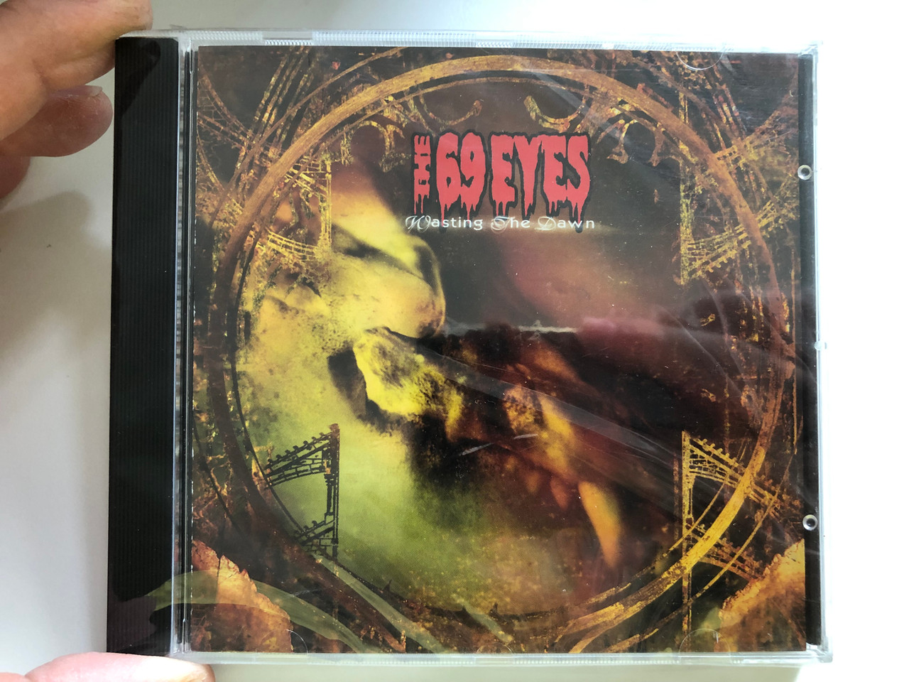 https://cdn10.bigcommerce.com/s-62bdpkt7pb/products/0/images/227219/The_69_Eyes_Wasting_The_Dawn_Roadrunner_Records_Audio_CD_1999_RR_8636-2_1__16069.1652247449.1280.1280.JPG?c=2&_gl=1*16wjgfh*_ga*MjA2NTIxMjE2MC4xNTkwNTEyNTMy*_ga_WS2VZYPC6G*MTY1MjI0NzQ2MS4zOTEuMC4xNjUyMjQ3NDYxLjYw
