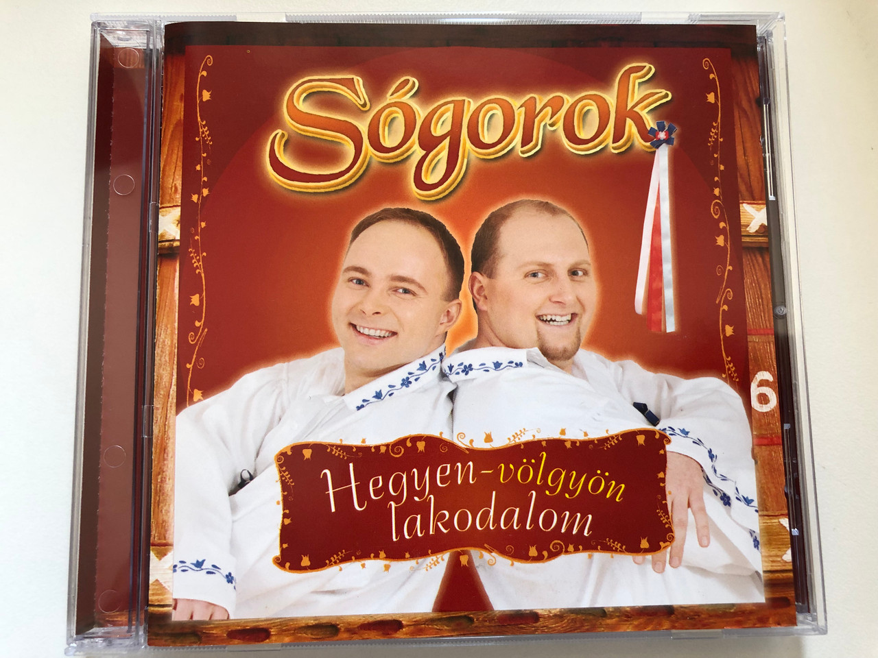 https://cdn10.bigcommerce.com/s-62bdpkt7pb/products/0/images/227261/Sogorok_-_Hegyen-volgyon_lakodalom_Sony_BMG_Music_Audio_CD_2007_88697096072_1__70605.1652252334.1280.1280.JPG?c=2&_gl=1*10ilhbw*_ga*MjA2NTIxMjE2MC4xNTkwNTEyNTMy*_ga_WS2VZYPC6G*MTY1MjI0NzQ2MS4zOTEuMS4xNjUyMjUyMDY0LjYw