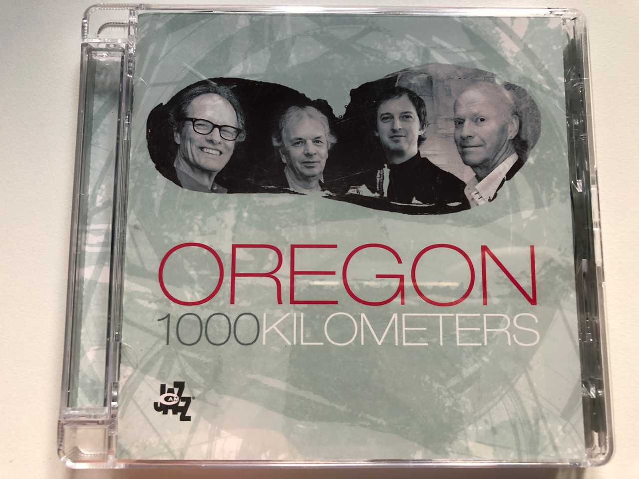 https://cdn10.bigcommerce.com/s-62bdpkt7pb/products/0/images/227642/Oregon_1000_Kilometers_C.A.M._Jazz_Audio_CD_2007_CAMJ_7803-2_1__93273.1652718824.1280.1280.JPG?c=2&_gl=1*jxbazu*_ga*MjA2NTIxMjE2MC4xNTkwNTEyNTMy*_ga_WS2VZYPC6G*MTY1MjcwODk4OS4zOTguMS4xNjUyNzE4Nzk1LjYw