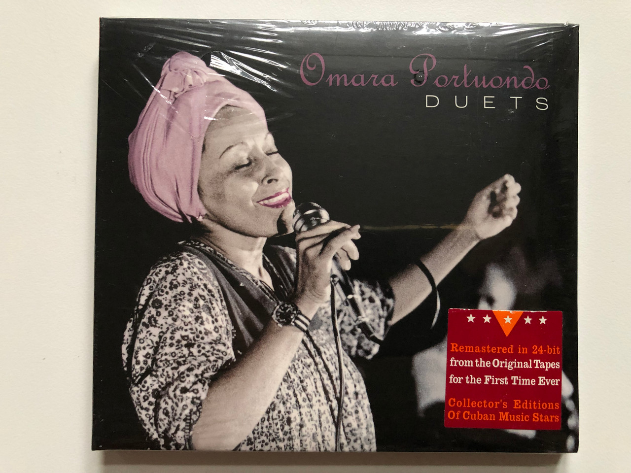 https://cdn10.bigcommerce.com/s-62bdpkt7pb/products/0/images/228077/Omara_Portuondo_Duets_Remastered_in_24-bit_from_the_Original_Tapes_for_the_First_Time_Ever_Collectors_Editions_of_Cuban_Music_Stars_Malanga_Music_Audio_CD_2007_MM812_1__08406.1652961469.1280.1280.JPG?c=2&_gl=1*vn2cxo*_ga*MjA2NTIxMjE2MC4xNTkwNTEyNTMy*_ga_WS2VZYPC6G*MTY1Mjk2MDk4Ni40MDQuMS4xNjUyOTYxMzM0LjI1