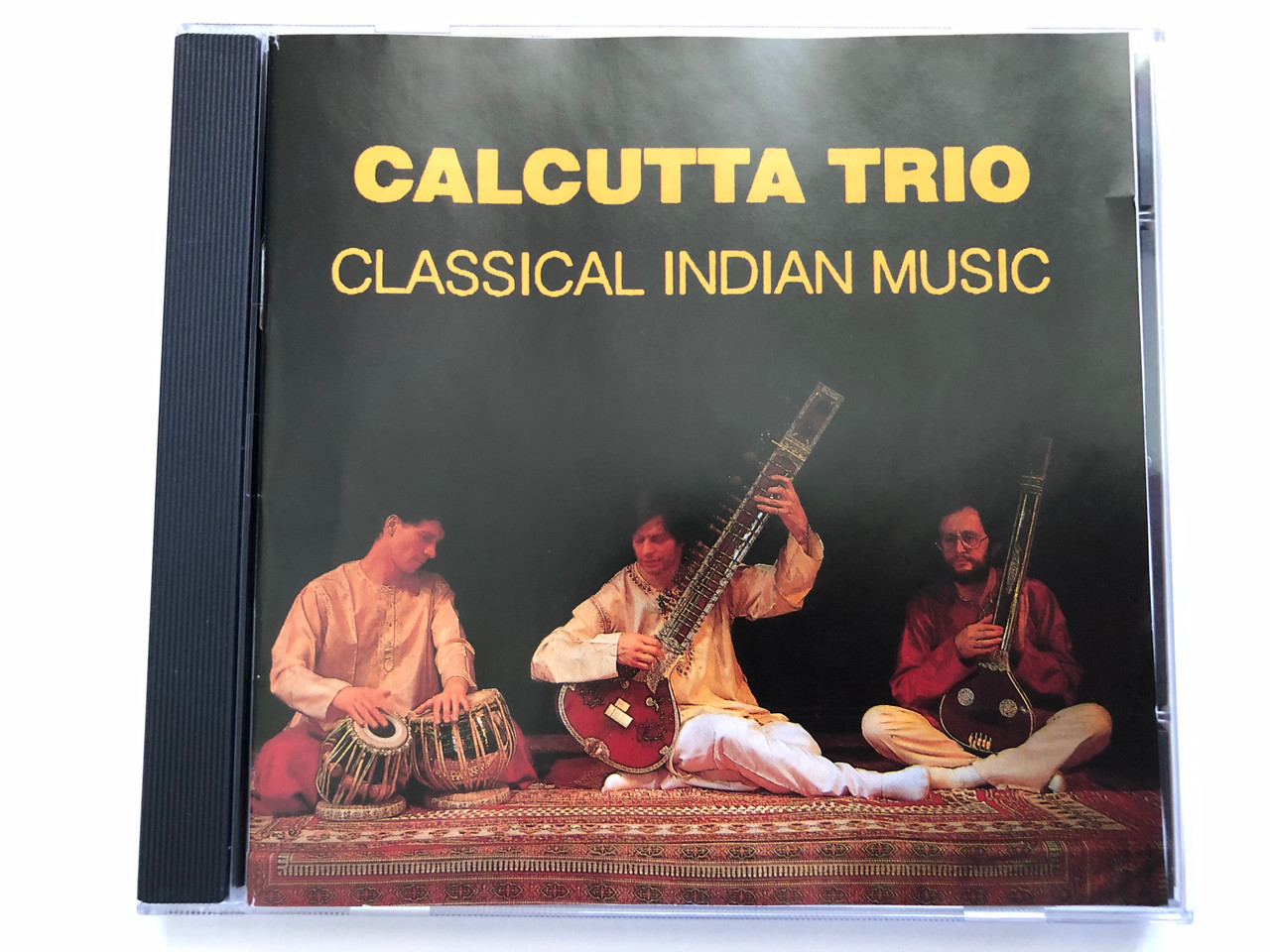 https://cdn10.bigcommerce.com/s-62bdpkt7pb/products/0/images/228853/Calcutta_Trio_-_Classical_Indian_Music_Ananda_Sounds_Audio_CD_ASCD_021_1__05921.1653543425.1280.1280.JPG?c=2&_gl=1*ttb28r*_ga*MjA2NTIxMjE2MC4xNTkwNTEyNTMy*_ga_WS2VZYPC6G*MTY1MzUzODI3Ny40MTAuMS4xNjUzNTQzMjc0LjQ4