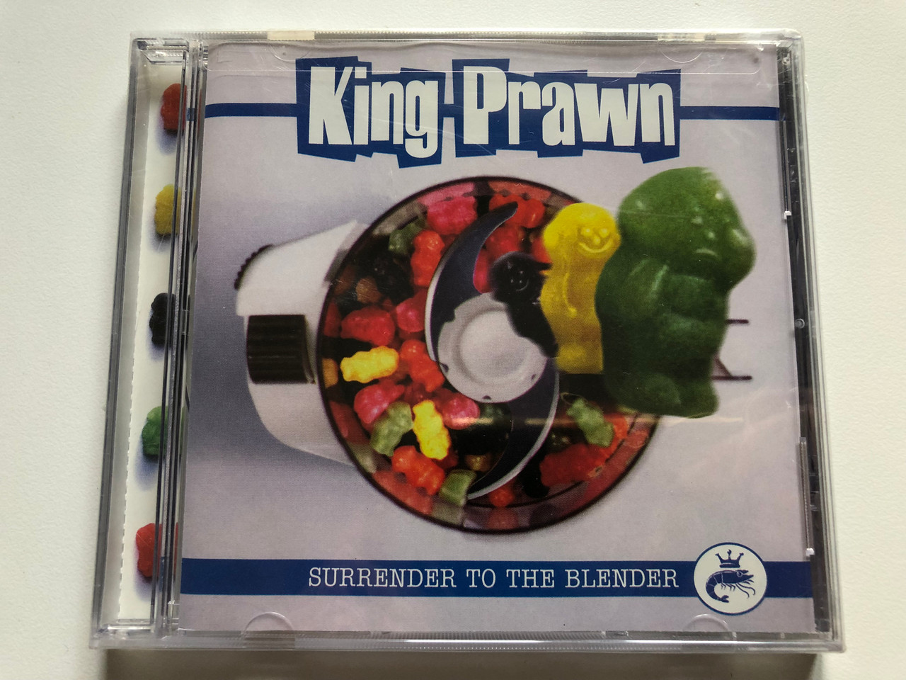 https://cdn10.bigcommerce.com/s-62bdpkt7pb/products/0/images/229174/King_Prawn_Surrender_To_The_Blender_Spitfire_Records_Audio_CD_2000_5053-2_1__64262.1653633126.1280.1280.JPG?c=2&_gl=1*g7r4vl*_ga*MjA2NTIxMjE2MC4xNTkwNTEyNTMy*_ga_WS2VZYPC6G*MTY1MzYyMzY5Mi40MTMuMS4xNjUzNjMyOTM3LjYw