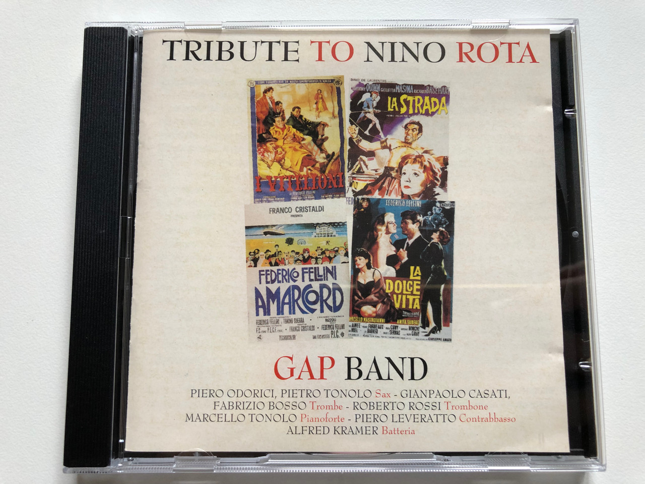 https://cdn10.bigcommerce.com/s-62bdpkt7pb/products/0/images/230152/Tribute_To_Nino_Rota_-_Gap_Band_Piero_Odorici_Pietro_Tonolo_Sax_Gianpaolo_Casati_Fabrizio_Bosso_Trombe_Roberto_Rossi_Trombone_Marcello_Tonolo_Pianoforte_Nel_Jazz_Audio_CD_1995_1__84222.1653923152.1280.1280.JPG?c=2&_gl=1*12owgta*_ga*MjA2NTIxMjE2MC4xNTkwNTEyNTMy*_ga_WS2VZYPC6G*MTY1MzkxODkyNC40MTQuMS4xNjUzOTIzMTM5LjYw