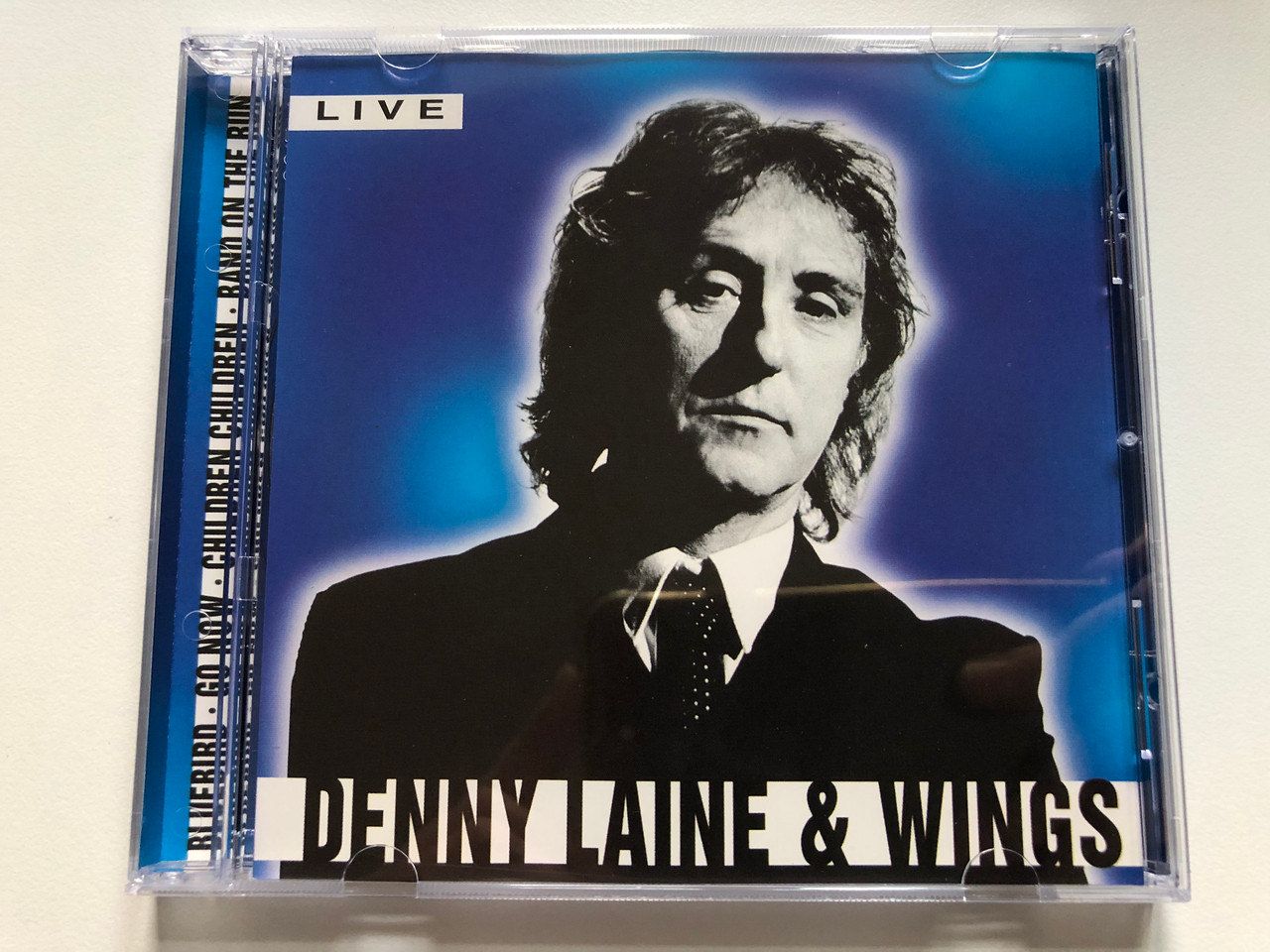 https://cdn10.bigcommerce.com/s-62bdpkt7pb/products/0/images/231079/Denny_Laine_Wings_-_Live_Bluebird_Go_Now_Children_Children_Band_On_The_Run_ACD_Audio_CD_CD_154_1__79758.1654180121.1280.1280.JPG?c=2&_gl=1*10fqv4f*_ga*MjA2NTIxMjE2MC4xNTkwNTEyNTMy*_ga_WS2VZYPC6G*MTY1NDE3Nzk5OS40MTkuMS4xNjU0MTc5ODc3LjM1