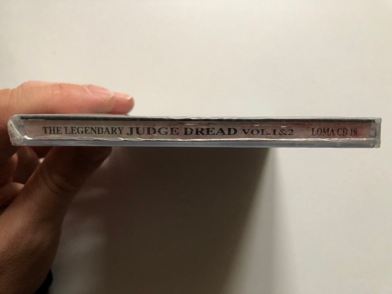 https://cdn10.bigcommerce.com/s-62bdpkt7pb/products/0/images/231254/The_Legendary_Judge_Dread_Vol_1_King_Of_Rudeness_Volume_2_Reggae_And_Ska_Years_Dojo_Limited_Audio_CD_1994_LOMA_CD_19_3__48666.1654237794.1280.1280.JPG?c=2&_gl=1*48hbaf*_ga*MjA2NTIxMjE2MC4xNTkwNTEyNTMy*_ga_WS2VZYPC6G*MTY1NDIzNDU5Mi40MjEuMS4xNjU0MjM3Nzc3LjYw