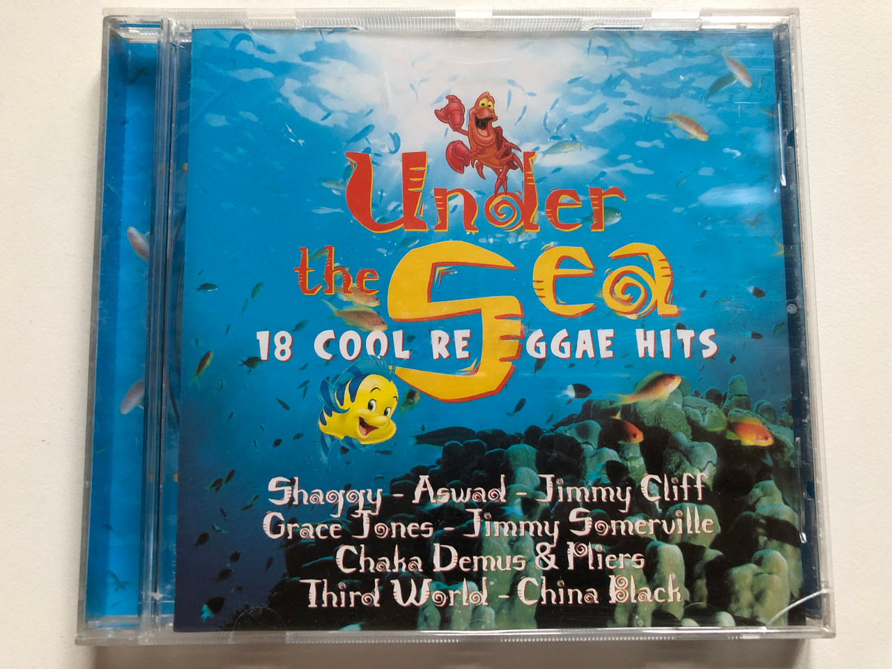 https://cdn10.bigcommerce.com/s-62bdpkt7pb/products/0/images/231307/Under_The_Sea_-_18_Cool_Reggae_Hits_Shaggy_Aswad_Jimmy_Cliff_Grace_Jones_Jimmy_Somerville_Chaka_Demus_Pliers_Third_World_China_Black_Walt_Disney_Records_Audio_CD_1998_0606892_1__32446.1654246452.1280.1280.JPG?c=2&_gl=1*4amts5*_ga*MjA2NTIxMjE2MC4xNTkwNTEyNTMy*_ga_WS2VZYPC6G*MTY1NDIzNDU5Mi40MjEuMS4xNjU0MjQ1OTQ2LjIw