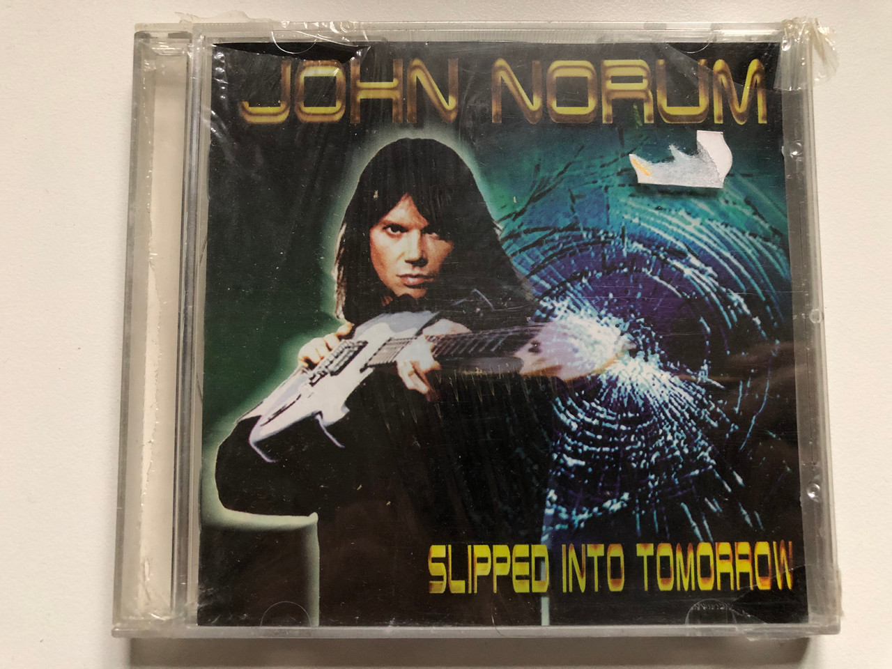 https://cdn10.bigcommerce.com/s-62bdpkt7pb/products/0/images/233118/John_Norum_Slipped_Into_Tomorrow_Mascot_Records_Audio_CD_2000_M_7049_2_1__30676.1654797903.1280.1280.JPG?c=2&_gl=1*1rxabzi*_ga*MjA2NTIxMjE2MC4xNTkwNTEyNTMy*_ga_WS2VZYPC6G*MTY1NDc5NTk2MS40MjcuMS4xNjU0Nzk3NzM1LjM4