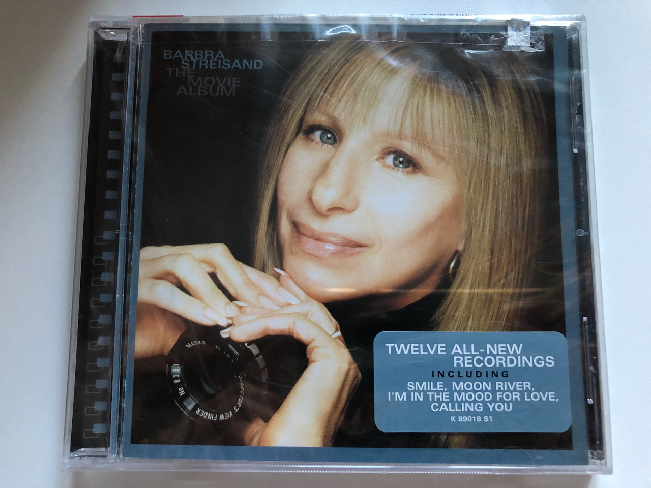 https://cdn10.bigcommerce.com/s-62bdpkt7pb/products/0/images/233847/Barbra_Streisand_The_Movie_Album_Twelve_All-New_Recordings._Including_Smile_Moon_River_Im_In_The_Mood_For_Love_Calling_You_Columbia_Audio_CD_2003_CK_89018_1__71100.1655208847.1280.1280.JPG?c=2&_gl=1*18ixqy3*_ga*MjA2NTIxMjE2MC4xNTkwNTEyNTMy*_ga_WS2VZYPC6G*MTY1NTIwNzU4OC40MzMuMS4xNjU1MjA4NTYzLjU4