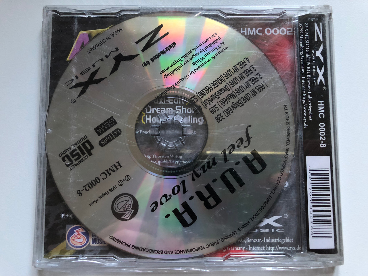 https://cdn10.bigcommerce.com/s-62bdpkt7pb/products/0/images/234006/A.U.R.A._Feel_My_Love_Happy_Music_Audio_CD_1998_HMC_0002-8_2__58606.1655219601.1280.1280.JPG?c=2&_gl=1*18eeikz*_ga*MjA2NTIxMjE2MC4xNTkwNTEyNTMy*_ga_WS2VZYPC6G*MTY1NTIxNzA3Mi40MzQuMS4xNjU1MjE5NTAyLjEw