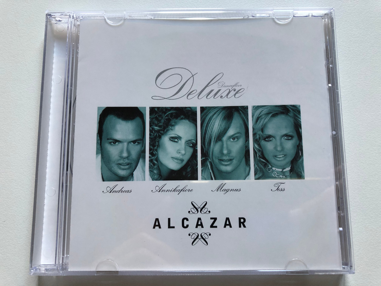 https://cdn10.bigcommerce.com/s-62bdpkt7pb/products/0/images/234103/Dancefloor_Deluxe_-_Alcazar_-_Andreas_Annikafiore_Magnus_Tess_BMG_Sweden_Audio_CD_2005_82876_68267_2_1__90940.1655225502.1280.1280.JPG?c=2&_gl=1*1u1ncd1*_ga*MjA2NTIxMjE2MC4xNTkwNTEyNTMy*_ga_WS2VZYPC6G*MTY1NTIxNzA3Mi40MzQuMS4xNjU1MjI1MzI1LjI.