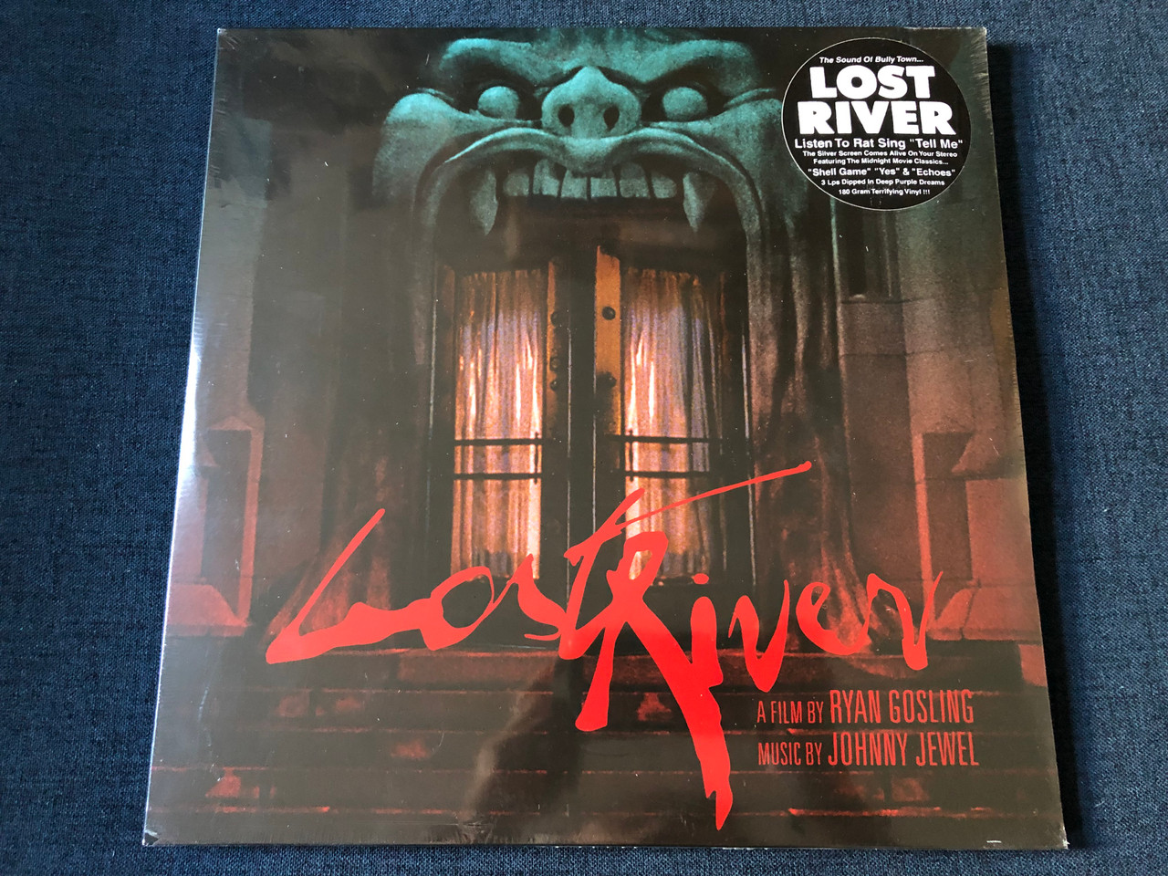 https://cdn10.bigcommerce.com/s-62bdpkt7pb/products/0/images/234153/Lost_River_-_A_Film_By_Ryan_Gosling_Music_By_Johnny_Jewel_Listen_To_Rat_Sing_Tell_Me_The_Silver_Screen_Comes_Alive_On_Your_Stereo_Featuring_The_Midnight_Movie_Classics..._Shell_Game_1__78770.1655276869.1280.1280.JPG?c=2&_gl=1*1916dlp*_ga*MjA2NTIxMjE2MC4xNTkwNTEyNTMy*_ga_WS2VZYPC6G*MTY1NTI3MTU1MS40MzUuMS4xNjU1Mjc2ODYyLjYw