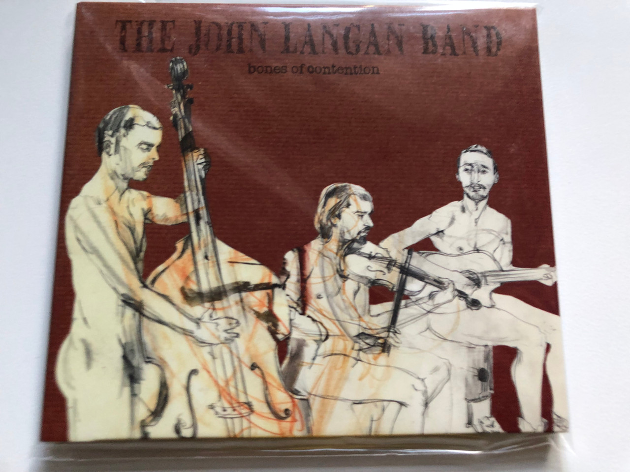 https://cdn10.bigcommerce.com/s-62bdpkt7pb/products/0/images/235302/The_John_Langan_Band_-_Bones_of_contention_The_John_Langan_Band_Audio_CD_2013_5055701693063_1__17217.1655901879.1280.1280.JPG?c=2&_gl=1*t600y2*_ga*MjA2NTIxMjE2MC4xNTkwNTEyNTMy*_ga_WS2VZYPC6G*MTY1NTkwMDk2NS40NDcuMS4xNjU1OTAxNjIxLjE.