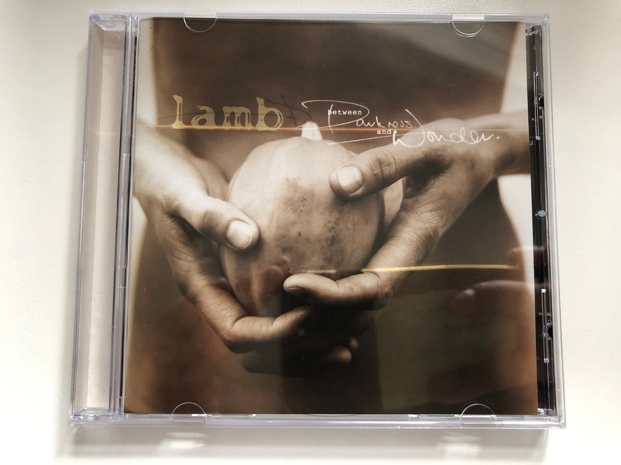 https://cdn10.bigcommerce.com/s-62bdpkt7pb/products/0/images/235502/Lamb_Between_Darkness_And_Wonder_Mercury_Audio_CD_2003_9865701_1__79541.1656008382.1280.1280.JPG?c=2&_gl=1*qxpbde*_ga*MjA2NTIxMjE2MC4xNTkwNTEyNTMy*_ga_WS2VZYPC6G*MTY1NTk5OTA4Ni40NTAuMS4xNjU2MDA4Mjg3LjI0