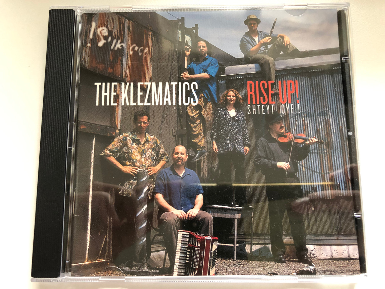 https://cdn10.bigcommerce.com/s-62bdpkt7pb/products/0/images/235616/The_Klezmatics_Rise_Up_Shteyt_Oyf_Rounder_Records_Audio_CD_2002_11661-3197-2_1__25537.1656051175.1280.1280.JPG?c=2&_gl=1*7damlg*_ga*MjA2NTIxMjE2MC4xNTkwNTEyNTMy*_ga_WS2VZYPC6G*MTY1NjA0NDk4Mi40NTEuMS4xNjU2MDUxMDM4LjQy