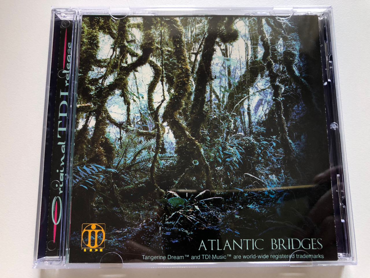 https://cdn10.bigcommerce.com/s-62bdpkt7pb/products/0/images/236027/Tangerine_Dream_Atlantic_Bridges_TDI_Music_Audio_CD_1998_TDI_CD002_1__20834.1656392866.1280.1280.JPG?c=2&_gl=1*ts77xb*_ga*MjA2NTIxMjE2MC4xNTkwNTEyNTMy*_ga_WS2VZYPC6G*MTY1NjM4OTY1OS40NTYuMS4xNjU2MzkyNzc5LjE2