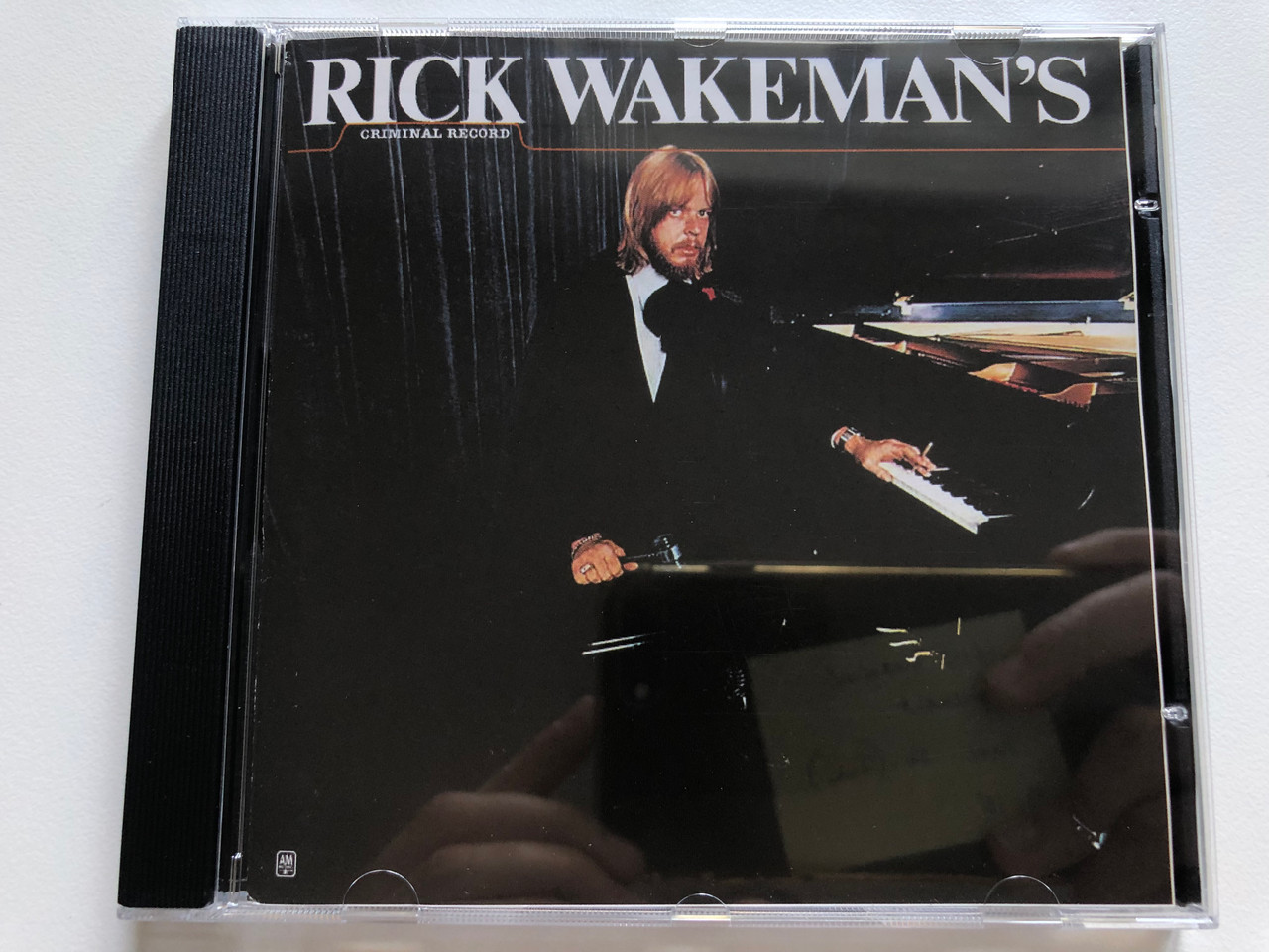 https://cdn10.bigcommerce.com/s-62bdpkt7pb/products/0/images/236939/Rick_Wakemans_Criminal_Record_AM_Records_Audio_CD_Stereo_UICY-9301_1__13209.1656963808.1280.1280.JPG?c=2&_gl=1*1yy283o*_ga*MjA2NTIxMjE2MC4xNTkwNTEyNTMy*_ga_WS2VZYPC6G*MTY1Njk2MTYyMC40NjYuMS4xNjU2OTYzODE2LjYw