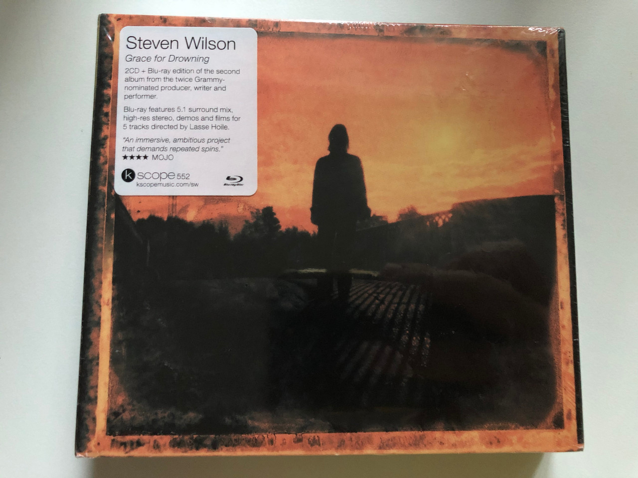https://cdn10.bigcommerce.com/s-62bdpkt7pb/products/0/images/241458/Steven_Wilson_Grace_For_Drowning_2CD_Blu-ray_edition_of_the_second_album_from_the_twice_Grammy_nominated_producer_writter_and_performer._Kscope_2x_Audio_CD_2011_Kscope_552_1__63686.1658496153.1280.1280.JPG?c=2&_gl=1*1dywj2o*_ga*MjA2NTIxMjE2MC4xNTkwNTEyNTMy*_ga_WS2VZYPC6G*MTY1ODQ5NTQ2MC40OTUuMS4xNjU4NDk1NTA2LjE0