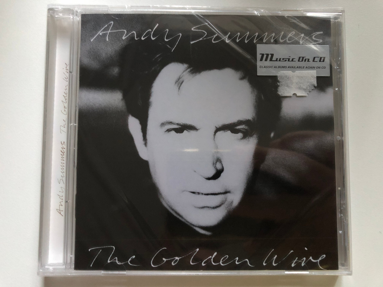 https://cdn10.bigcommerce.com/s-62bdpkt7pb/products/0/images/241470/Andy_Summers_The_Golden_Wire_Music_On_CD_Audio_CD_2015_MOCCD_13213_1__94156.1658499134.1280.1280.JPG?c=2&_gl=1*1o2j1ef*_ga*MjA2NTIxMjE2MC4xNTkwNTEyNTMy*_ga_WS2VZYPC6G*MTY1ODQ5NTQ2MC40OTUuMS4xNjU4NDk4OTkxLjUw