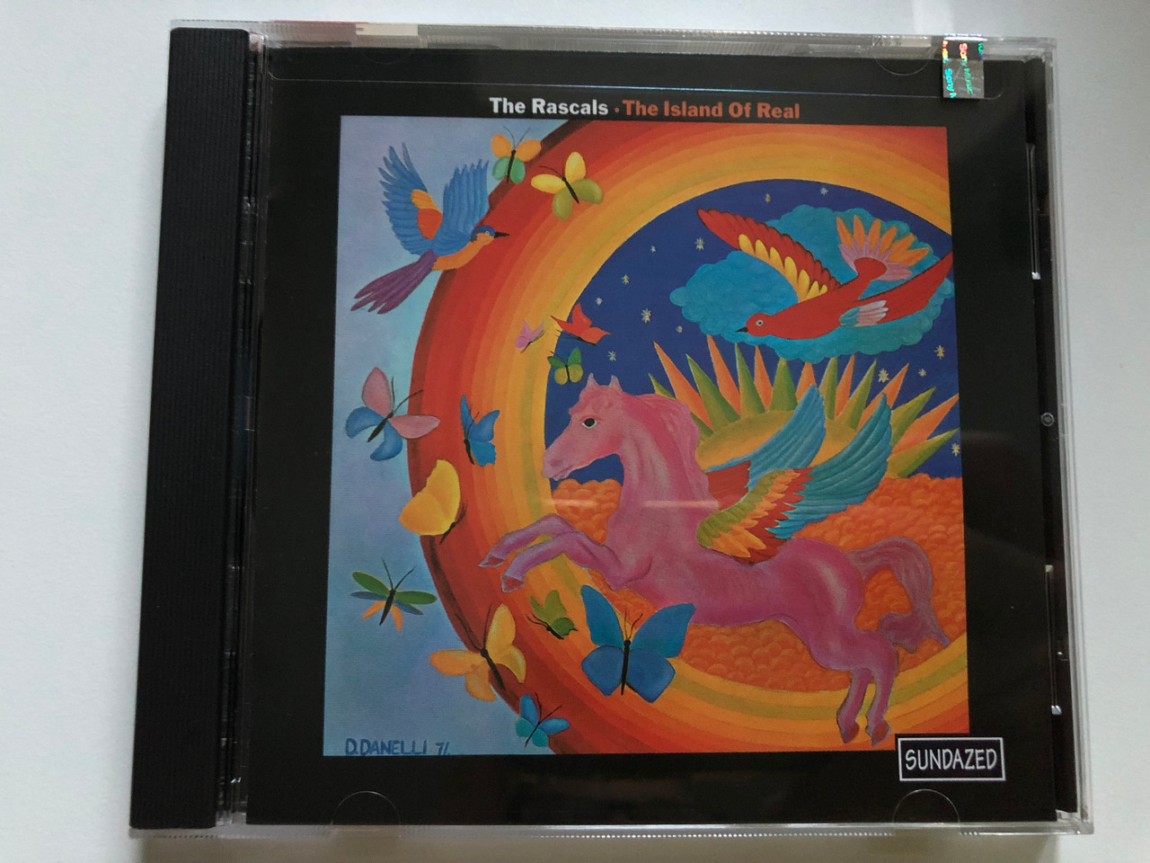 https://cdn10.bigcommerce.com/s-62bdpkt7pb/products/0/images/241503/The_Rascals_The_Island_Of_Real_Sundazed_Music_Audio_CD_1998_SC_6132_1__14138.1658503936.1280.1280.JPG?c=2&_gl=1*1i6xoj*_ga*MjA2NTIxMjE2MC4xNTkwNTEyNTMy*_ga_WS2VZYPC6G*MTY1ODQ5NTQ2MC40OTUuMS4xNjU4NTAzODI0LjM2