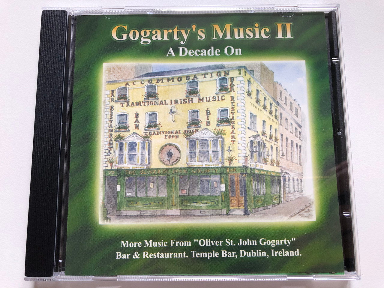 https://cdn10.bigcommerce.com/s-62bdpkt7pb/products/0/images/242973/Gogartys_Music_II_A_Decade_On_-_More_Music_From_Oliver_St._John_Gogarty_Bar_Restaurant._Temple_Bar_Dublin_Ireland._Gogartys_Music_Audio_CD_GMCD002_1__59732.1658898992.1280.1280.JPG?c=2&_gl=1*kp7dje*_ga*MjA2NTIxMjE2MC4xNTkwNTEyNTMy*_ga_WS2VZYPC6G*MTY1ODg5ODM0OC40OTkuMC4xNjU4ODk4MzQ4LjYw