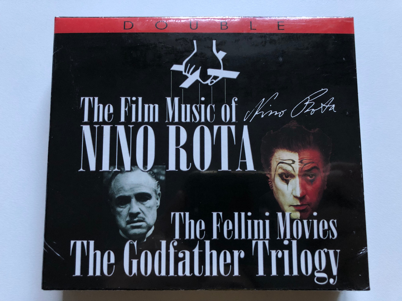 https://cdn10.bigcommerce.com/s-62bdpkt7pb/products/0/images/246389/The_Film_Music_of_Nino_Rota_-_The_Fellini_Movies_-_The_Godfather_Trilogy_Recording_Arts_2x_Audio_CD_2007_2X717_1__74315.1659706519.1280.1280.JPG?c=2&_gl=1*qh0sss*_ga*MjA2NTIxMjE2MC4xNTkwNTEyNTMy*_ga_WS2VZYPC6G*MTY1OTY5OTczMi41MTcuMS4xNjU5NzA2NTE0LjYw