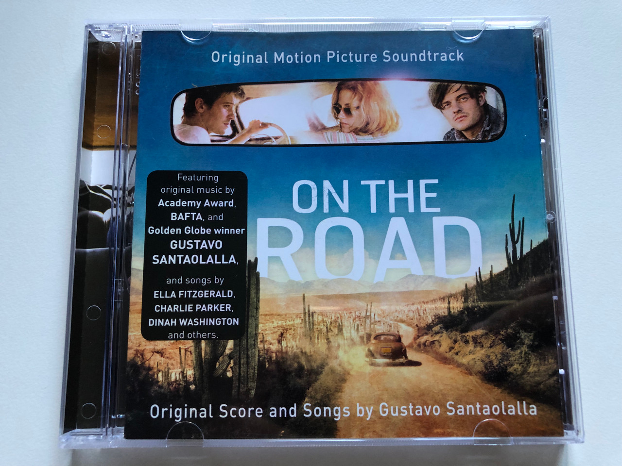 https://cdn10.bigcommerce.com/s-62bdpkt7pb/products/0/images/246785/On_The_Road_Original_Motion_Picture_Soundtrack_-_Original_Score_and_Songs_by_Gustavo_Santaolalla_Featuring_original_music_by_Academy_Award_BAFTA_The_Verve_Music_Group_Audio_CD_2012_06025_1__55418.1659952094.1280.1280.JPG?c=2&_gl=1*16u2i1g*_ga*MjA2NTIxMjE2MC4xNTkwNTEyNTMy*_ga_WS2VZYPC6G*MTY1OTkzNzgxMy41MTkuMS4xNjU5OTUxNjgwLjIx