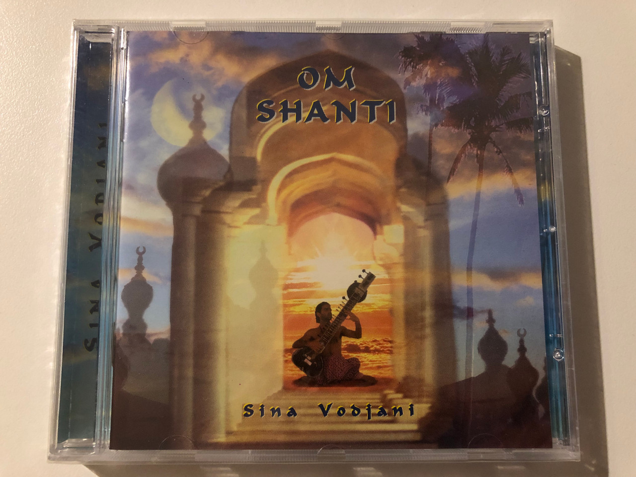 https://cdn10.bigcommerce.com/s-62bdpkt7pb/products/0/images/246979/Sina_Vodjani_Om_Shanti_Pastels_Audio_CD_1998_201768-213_1__81912.1660023536.1280.1280.JPG?c=2&_gl=1*1sgix7g*_ga*MjA2NTIxMjE2MC4xNTkwNTEyNTMy*_ga_WS2VZYPC6G*MTY2MDAxMzI2MS41MjAuMS4xNjYwMDIzMzQ2LjM3