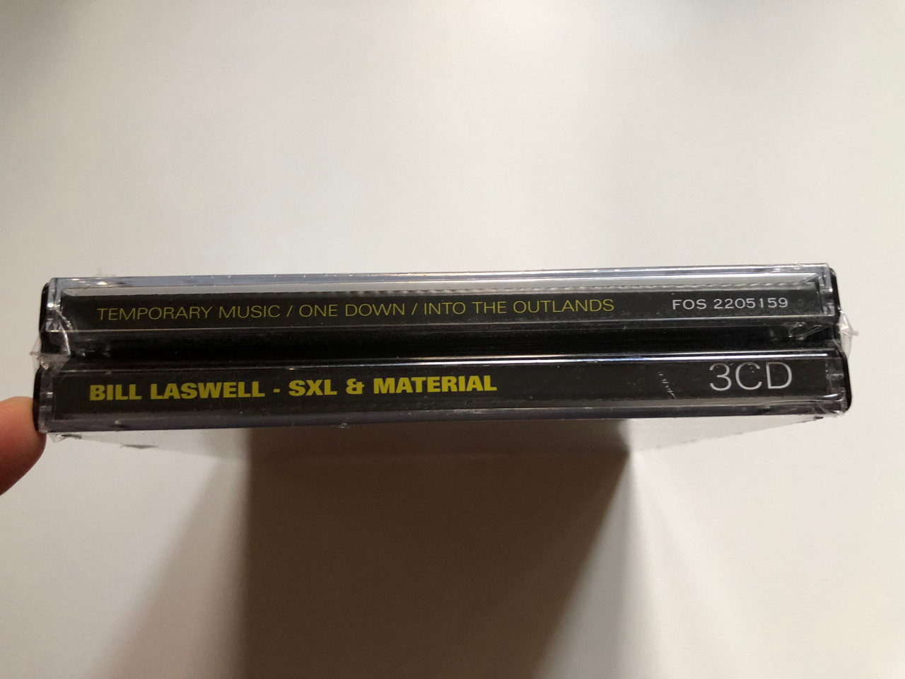 https://cdn10.bigcommerce.com/s-62bdpkt7pb/products/0/images/249230/SXL_Material_-_Bill_Laswell_-_Temporary_Music_One_Down_Into_The_Outlands_Album_Collection_Factory_Of_Sounds_3x_Audio_CD_2018_FOS_2205159_3__18142.1660839529.1280.1280.JPG?c=2&_gl=1*mjowcc*_ga*MjA2NTIxMjE2MC4xNTkwNTEyNTMy*_ga_WS2VZYPC6G*MTY2MDgyNjg1NS41MzEuMS4xNjYwODM5NTA2LjYwLjAuMA..