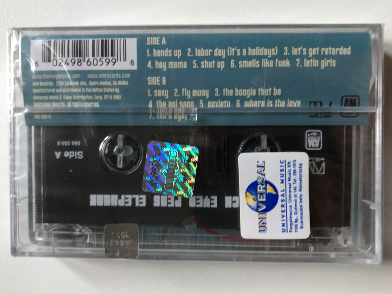 https://cdn10.bigcommerce.com/s-62bdpkt7pb/products/0/images/249868/The_Black_Eyed_Peas_Elephunk_AM_Records_Audio_Cassette_2003_986_059-9_2__35705.1661150377.1280.1280.JPG?c=2&_gl=1*uafxoe*_ga*MjA2NTIxMjE2MC4xNTkwNTEyNTMy*_ga_WS2VZYPC6G*MTY2MTE1MDA1NS41MzMuMC4xNjYxMTUwMDU1LjYwLjAuMA..