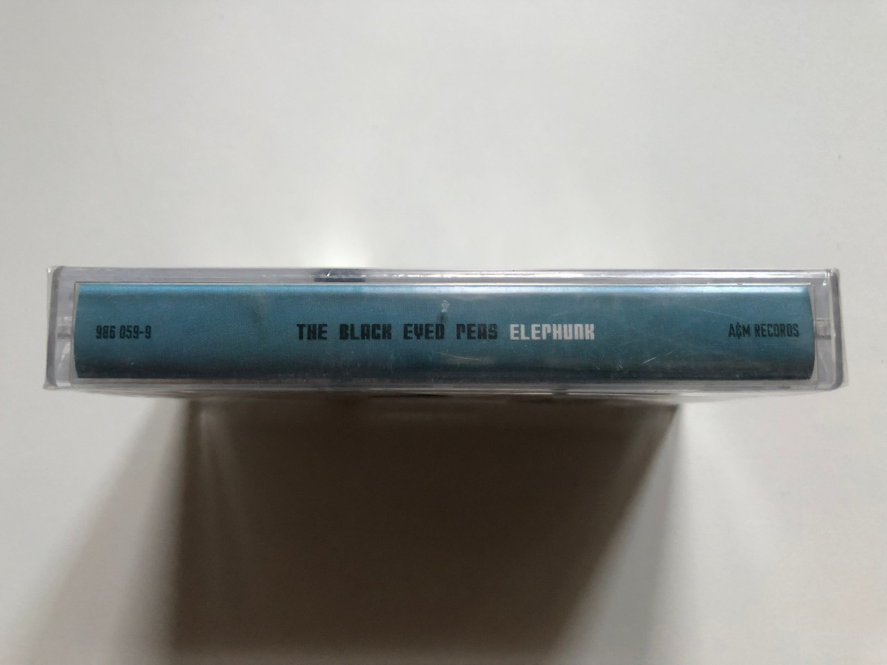 https://cdn10.bigcommerce.com/s-62bdpkt7pb/products/0/images/249869/The_Black_Eyed_Peas_Elephunk_AM_Records_Audio_Cassette_2003_986_059-9_3__09196.1661150378.1280.1280.JPG?c=2&_gl=1*uafxoe*_ga*MjA2NTIxMjE2MC4xNTkwNTEyNTMy*_ga_WS2VZYPC6G*MTY2MTE1MDA1NS41MzMuMC4xNjYxMTUwMDU1LjYwLjAuMA..