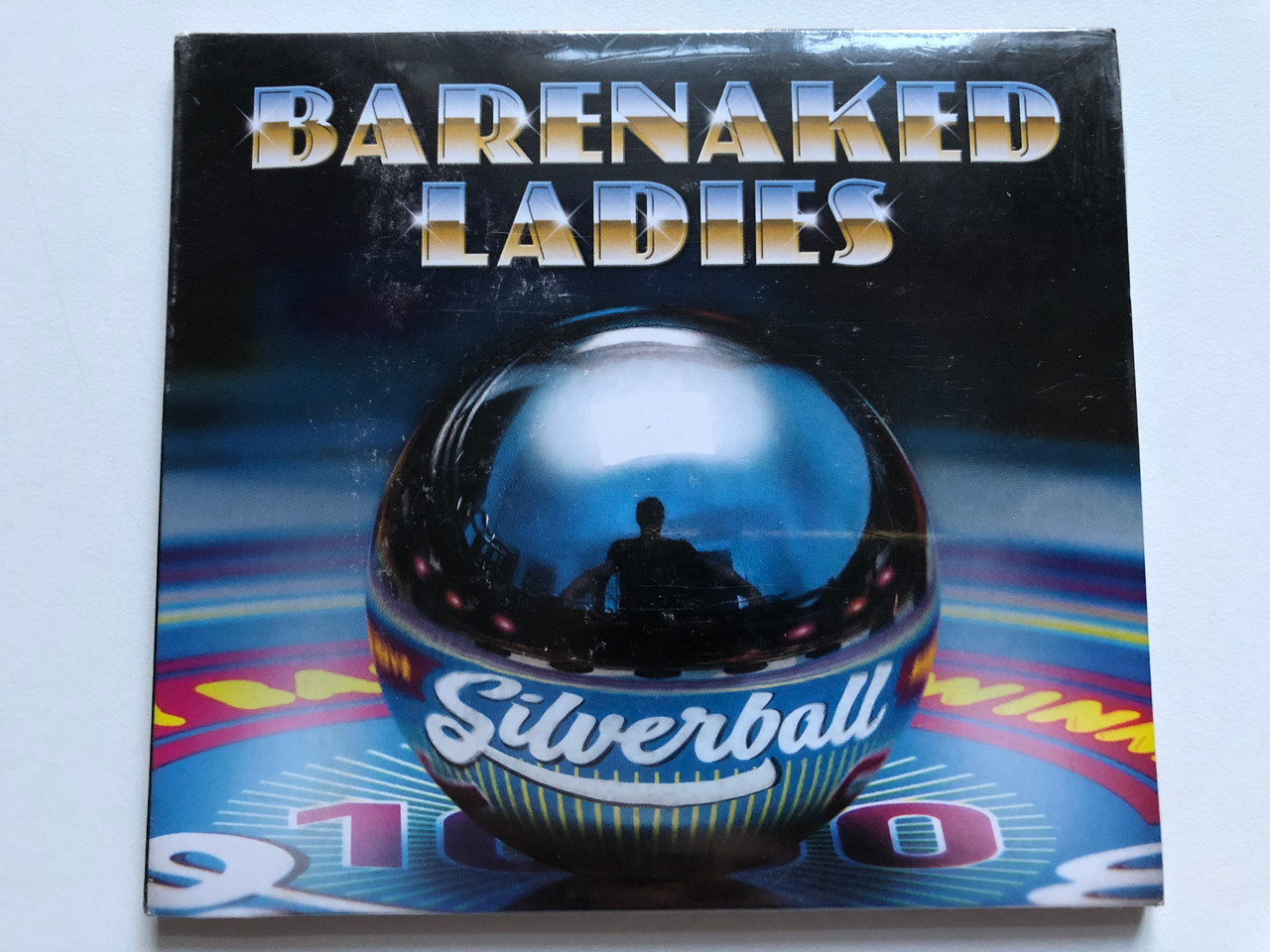 https://cdn10.bigcommerce.com/s-62bdpkt7pb/products/0/images/251043/Barenaked_Ladies_Silverball_Raisin_Records_Audio_CD_2015_5707845823_1__15412.1661330561.1280.1280.JPG?c=2&_gl=1*1xfjaf3*_ga*MjA2NTIxMjE2MC4xNTkwNTEyNTMy*_ga_WS2VZYPC6G*MTY2MTMxOTg5Ni41MzYuMS4xNjYxMzMwNDgxLjUzLjAuMA..