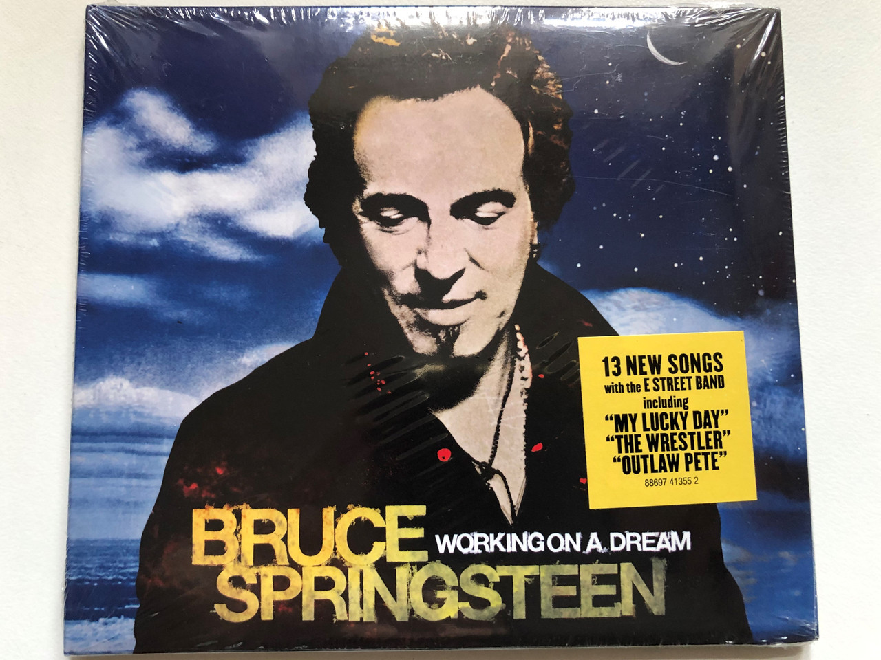 https://cdn10.bigcommerce.com/s-62bdpkt7pb/products/0/images/252993/Bruce_Springsteen_Working_On_A_Dream_13_New_Songs_with_the_E_Street_Band_including_My_Lucky_Day_The_Wrestler_Outlaw_Pete_Columbia_Audio_CD_2009_88697_41355_2_1__56988.1661969213.1280.1280.JPG?c=2&_gl=1*1brq8nz*_ga*MjA2NTIxMjE2MC4xNTkwNTEyNTMy*_ga_WS2VZYPC6G*MTY2MTk1NzAwOS41NDMuMS4xNjYxOTY4OTkwLjU2LjAuMA..