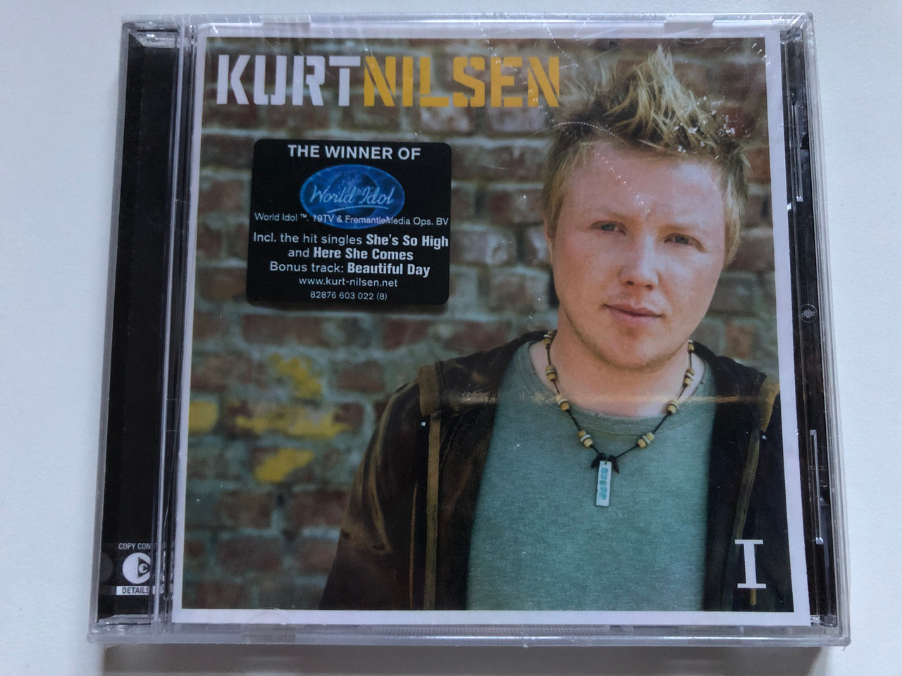 https://cdn10.bigcommerce.com/s-62bdpkt7pb/products/0/images/253148/Kurt_Nilsen_I_The_Winner_Of_World_Idol_Incl._the_hit_singles_Shes_So_High_and_Here_She_Comes_Bonus_track_Beautiful_Day_BMG_Norway_Audio_CD_2004_82876_603_022_1__09285.1662108261.1280.1280.JPG?c=2&_gl=1*1ag7hn3*_ga*MjA2NTIxMjE2MC4xNTkwNTEyNTMy*_ga_WS2VZYPC6G*MTY2MjEwNzMxMS41NDguMS4xNjYyMTA4MDQ2LjEzLjAuMA..