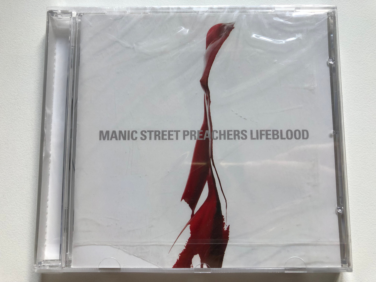 https://cdn10.bigcommerce.com/s-62bdpkt7pb/products/0/images/253585/Manic_Street_Preachers_Lifeblood_Sony_Music_UK_Audio_CD_2004_518885_2_1__00251.1663575769.1280.1280.JPG?c=2&_gl=1*5huzz5*_ga*MjA2NTIxMjE2MC4xNTkwNTEyNTMy*_ga_WS2VZYPC6G*MTY2MzU2Njc3MC41NTEuMS4xNjYzNTc1Nzk2LjYwLjAuMA..
