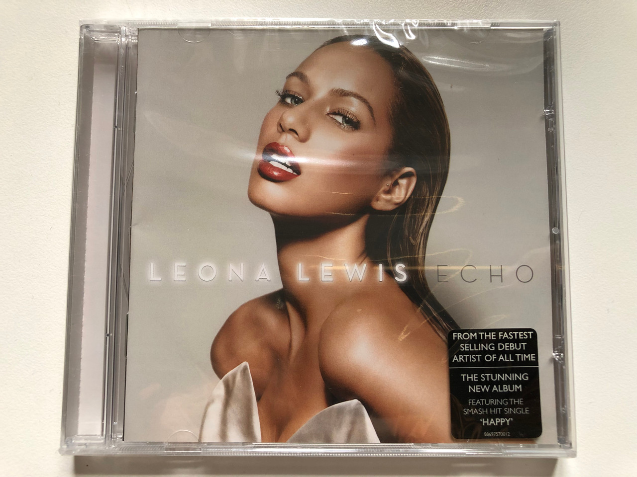 https://cdn10.bigcommerce.com/s-62bdpkt7pb/products/0/images/254067/Leona_Lewis_Echo_From_The_Fastest_Selling_Debut_Artist_Of_All_Time._The_Stunning_New_Album_Featuring_The_Smash_Hit_Single_Happy_Syco_Music_Audio_CD_2009_88697570012_1__53388.1663828951.1280.1280.JPG?c=2&_gl=1*144l94f*_ga*MjA2NTIxMjE2MC4xNTkwNTEyNTMy*_ga_WS2VZYPC6G*MTY2MzgyNjg3OC41NTcuMS4xNjYzODI4NzcwLjM4LjAuMA..