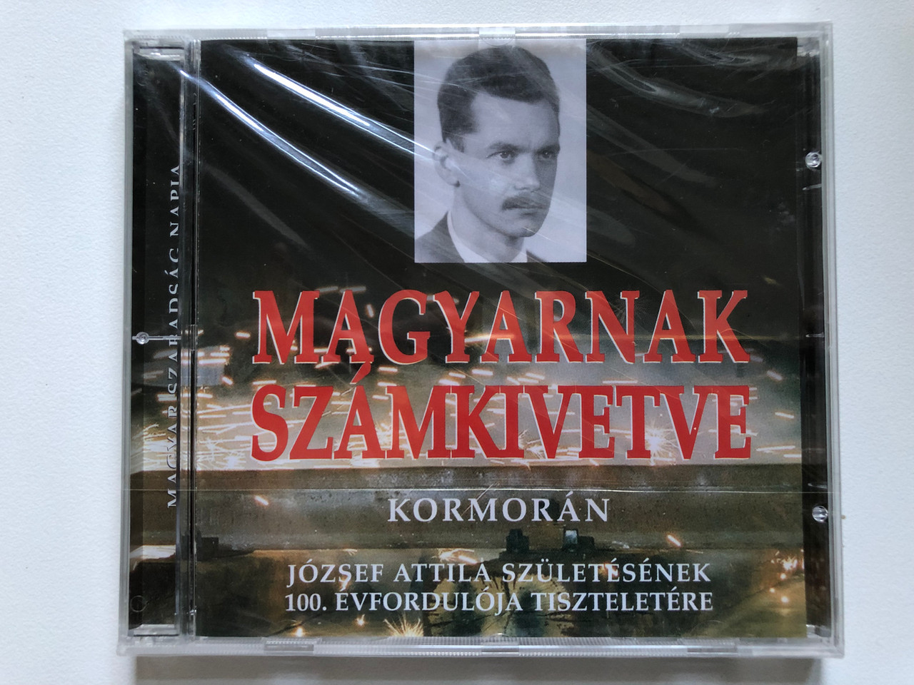 https://cdn10.bigcommerce.com/s-62bdpkt7pb/products/0/images/254962/Magyarnak_Szmkivetve_-_Kormorn_Jozsef_Attila_Szuletesenek_100._Evforduloja_Tiszteletere_Szabad_Tr_Kft._Audio_CD_2005_1__28899.1664387410.1280.1280.JPG?c=2&_gl=1*8gphoq*_ga*MjA2NTIxMjE2MC4xNTkwNTEyNTMy*_ga_WS2VZYPC6G*MTY2NDM4NTA3NC41NzEuMS4xNjY0Mzg3MDU1LjIyLjAuMA..