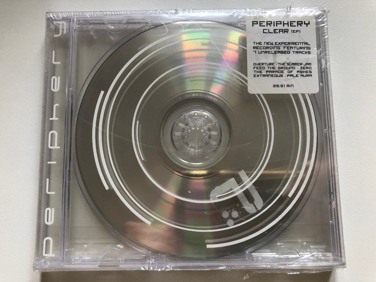https://cdn10.bigcommerce.com/s-62bdpkt7pb/products/0/images/255584/Periphery_Clear_EP_The_New_Experimental_Recording_Featuring_7_Unreleased_Tracks_-_Overture_The_Summer_Jam_Feed_The_Ground_Zero_The_Parade_Of_Ashes_Extraneous_Pale_Aura_2951_min._C_1__28838.1665030399.1280.1280.JPG?c=2&_gl=1*yjltgn*_ga*MjA2NTIxMjE2MC4xNTkwNTEyNTMy*_ga_WS2VZYPC6G*MTY2NTAyOTk3MC41ODQuMS4xNjY1MDMwMzg3LjYwLjAuMA..