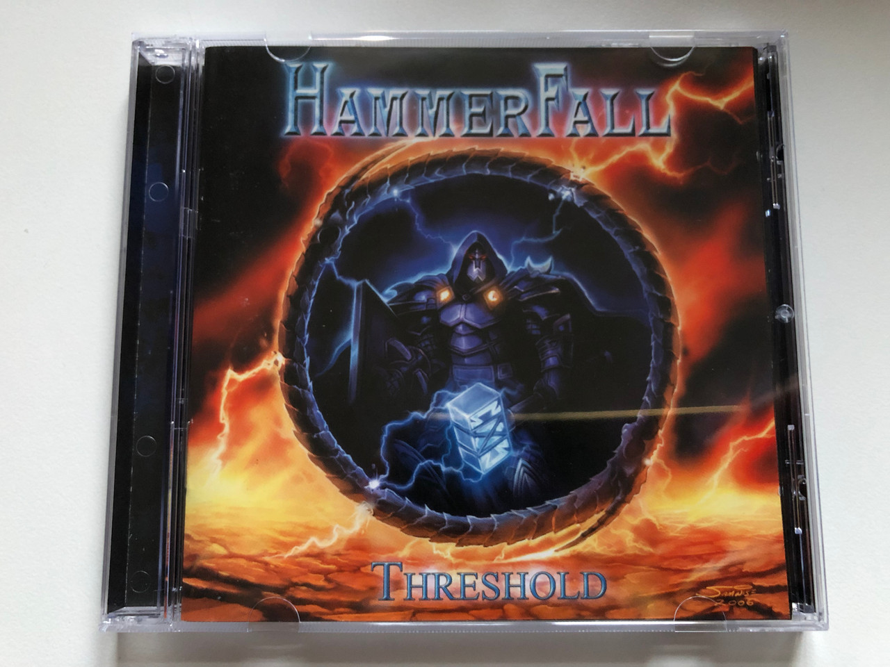 https://cdn10.bigcommerce.com/s-62bdpkt7pb/products/0/images/255669/HammerFall_Threshold_Hammer_License_Audio_CD_2006_HMRCD-NB1752_1__88399.1665052682.1280.1280.JPG?c=2&_gl=1*1x8lwgk*_ga*MjA2NTIxMjE2MC4xNTkwNTEyNTMy*_ga_WS2VZYPC6G*MTY2NTA0NDUxMS41ODUuMS4xNjY1MDUyNTU5LjUwLjAuMA..