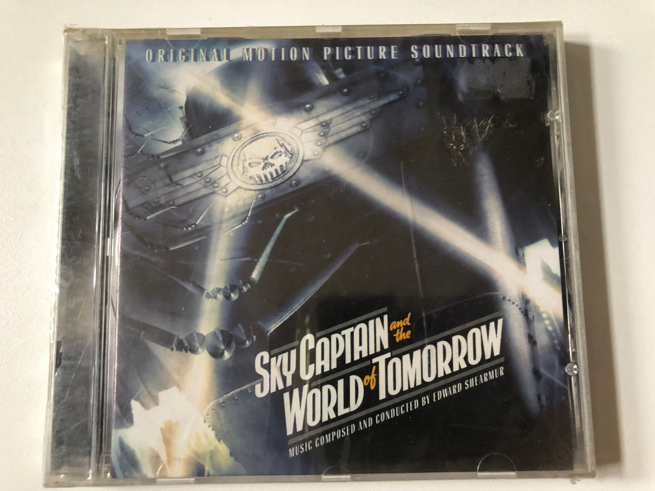 https://cdn10.bigcommerce.com/s-62bdpkt7pb/products/0/images/257243/Sky_Captain_And_The_World_Of_Tomorrow_Original_Motion_Picture_Soundtrack_-_Music_Composed_And_Conducted_By_Edward_Shearmur_Sony_Music_Soundtrax_Audio_CD_2004_SK_92932_1__33467.1667204255.1280.1280.JPG?c=2&_gl=1*xjqg67*_ga*MjA2NTIxMjE2MC4xNTkwNTEyNTMy*_ga_WS2VZYPC6G*MTY2NzIwMjA2OC42MDkuMS4xNjY3MjA0MDExLjIxLjAuMA..