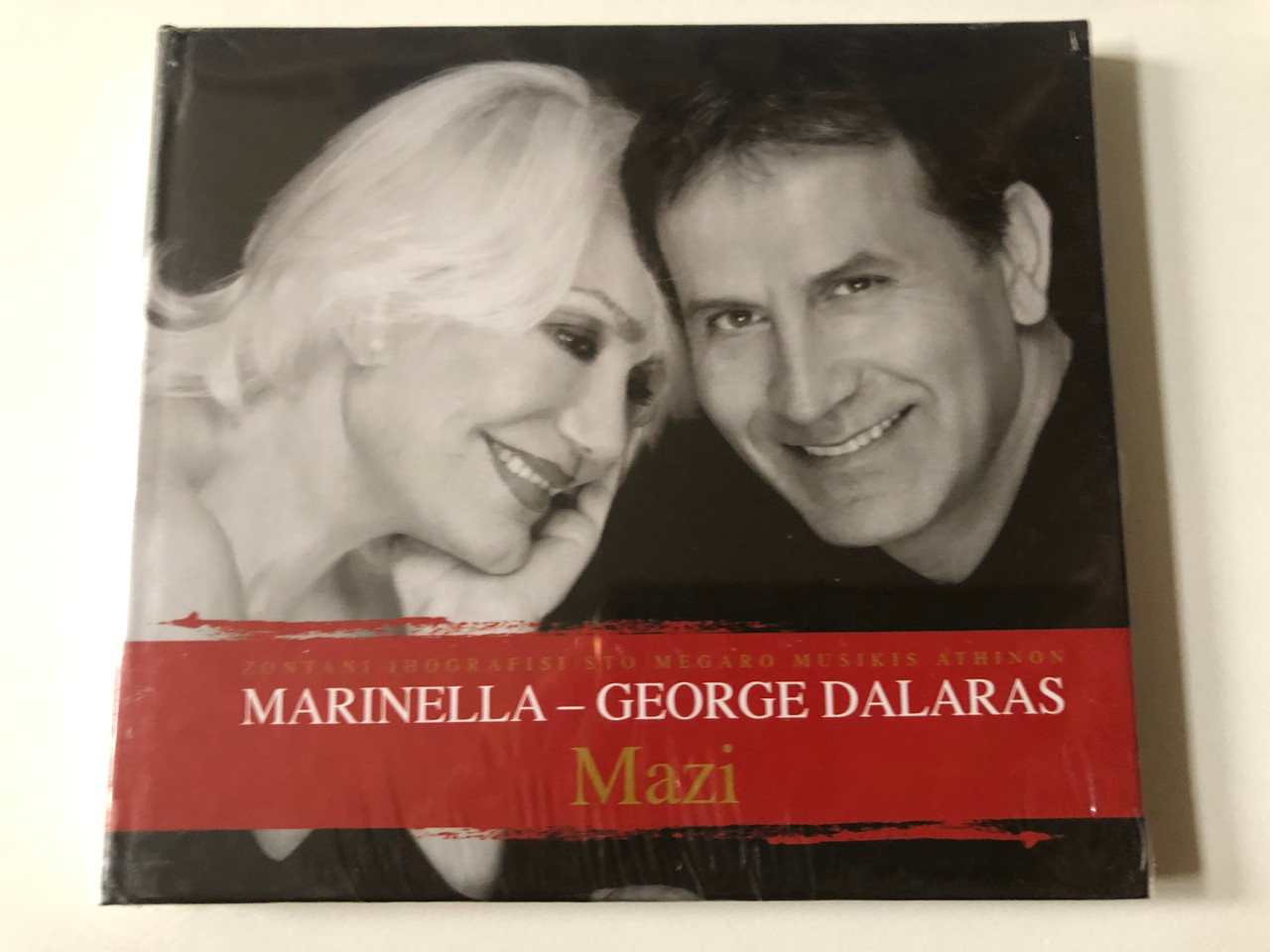 https://cdn10.bigcommerce.com/s-62bdpkt7pb/products/0/images/257363/Zontani_Ihografisi_Sto_Megaro_Musikis_Athinon_-_Marinella-George_Dalaras_Mazi_EMI_Audio_CD_2010_5099990630729_1__67953.1667285890.1280.1280.JPG?c=2&_gl=1*5esfpk*_ga*MjA2NTIxMjE2MC4xNTkwNTEyNTMy*_ga_WS2VZYPC6G*MTY2NzI4NTYzMC42MTEuMC4xNjY3Mjg1NjMwLjYwLjAuMA..