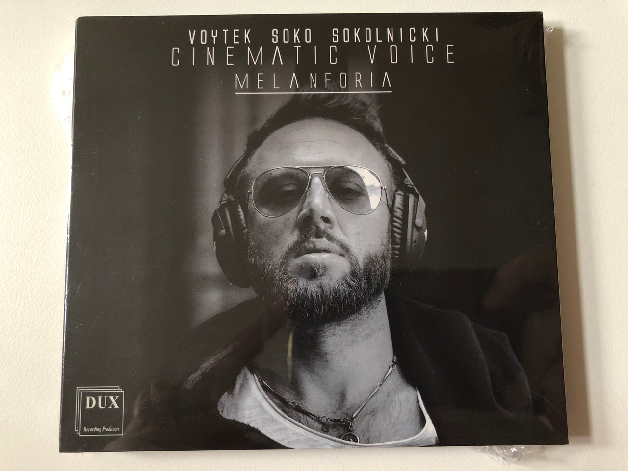 https://cdn10.bigcommerce.com/s-62bdpkt7pb/products/0/images/257603/Voytek_Soko_Sokolnicki_-_Cinematic_Voice_-_Melanforia_DUX_Recording_Producers_Audio_CD_2021_DUX_1457_1__33918.1667463885.1280.1280.JPG?c=2&_gl=1*f1fel5*_ga*MjA2NTIxMjE2MC4xNTkwNTEyNTMy*_ga_WS2VZYPC6G*MTY2NzQ1OTcxNy42MTUuMS4xNjY3NDYzNjA0LjE2LjAuMA..