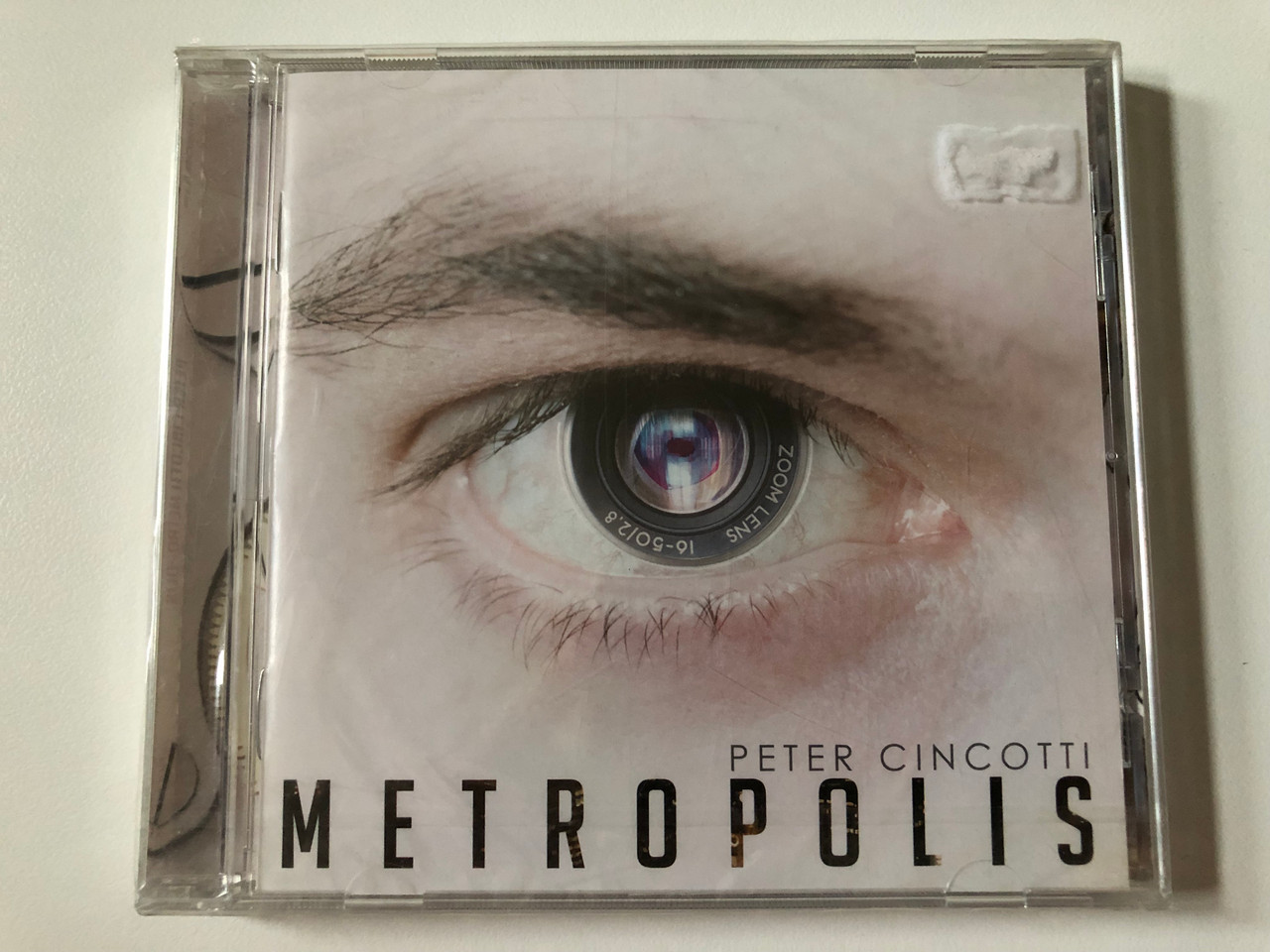 https://cdn10.bigcommerce.com/s-62bdpkt7pb/products/0/images/257757/Peter_Cincotti_Metropolis_Heads_Up_International_Audio_CD_2012_HUI-33862-02_1__07112.1667550782.1280.1280.JPG?c=2&_gl=1*8vrtie*_ga*MjA2NTIxMjE2MC4xNTkwNTEyNTMy*_ga_WS2VZYPC6G*MTY2NzU0NTYyOS42MTcuMS4xNjY3NTUwNjY4LjUxLjAuMA..